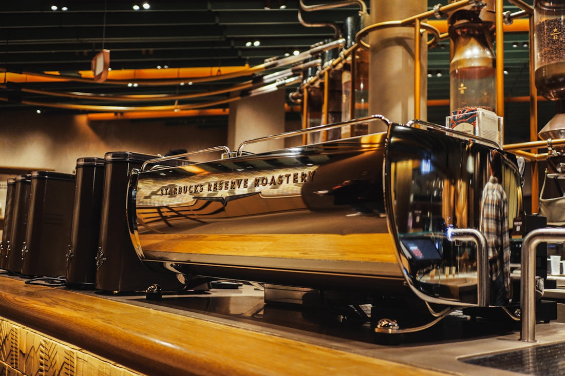Shiny coffee machine with intricate details is displayed.