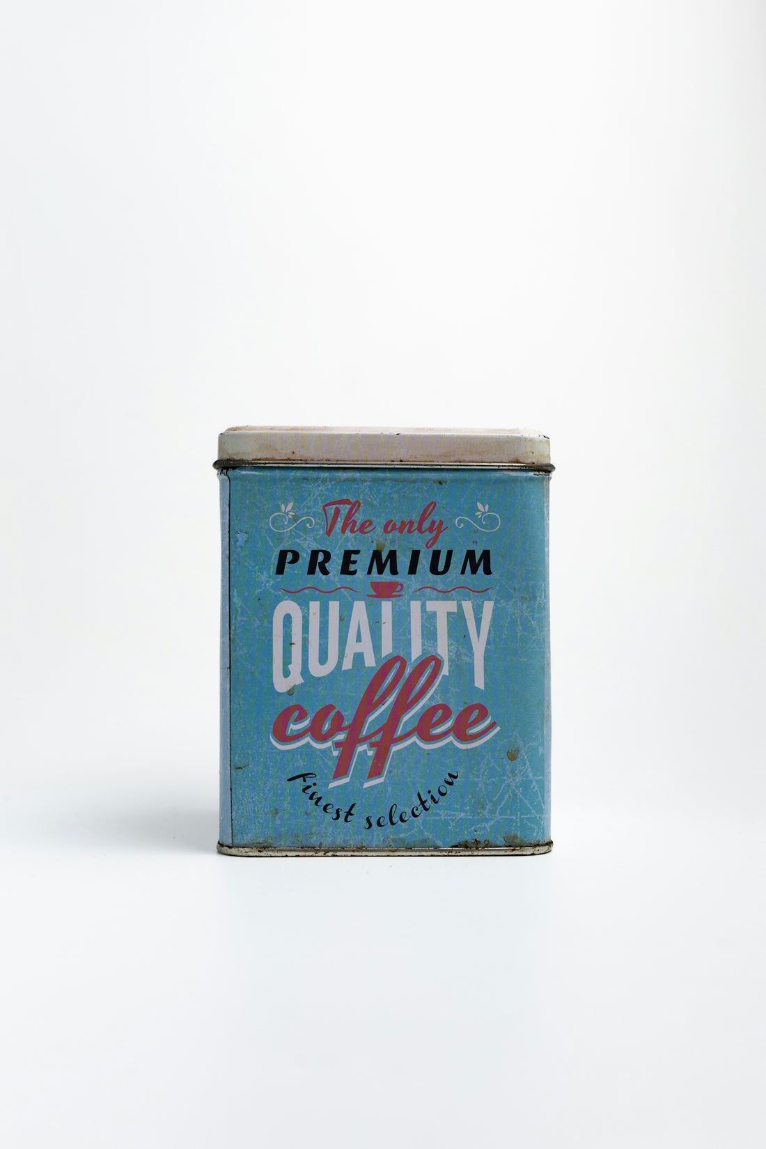 A vintage coffee can sits on a white background.