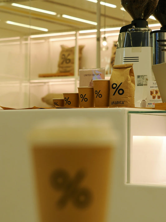 Coffee cups and bags with percentage logo
