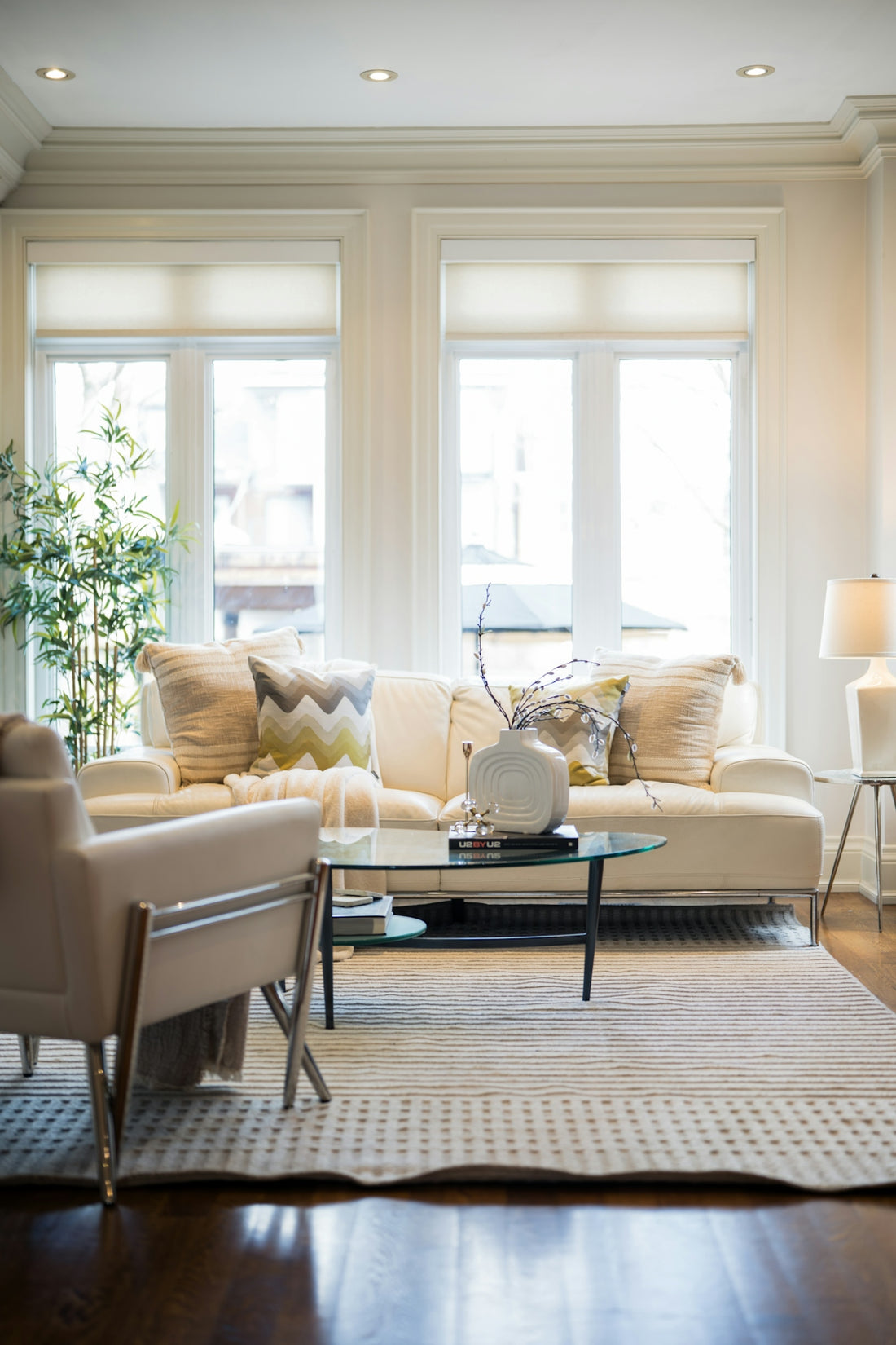 A bright, modern living room with a sofa and armchair.