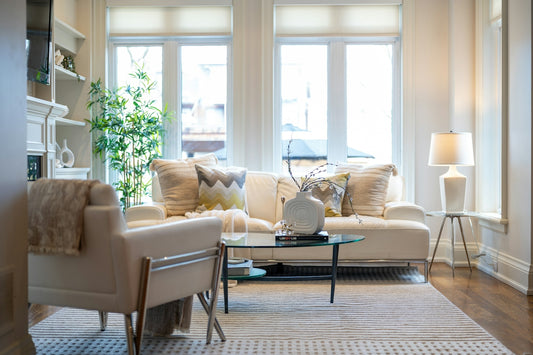 A bright, elegant living room with a sofa and armchair