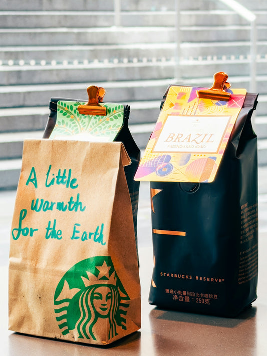 Two bags of starbucks coffee beans with clips