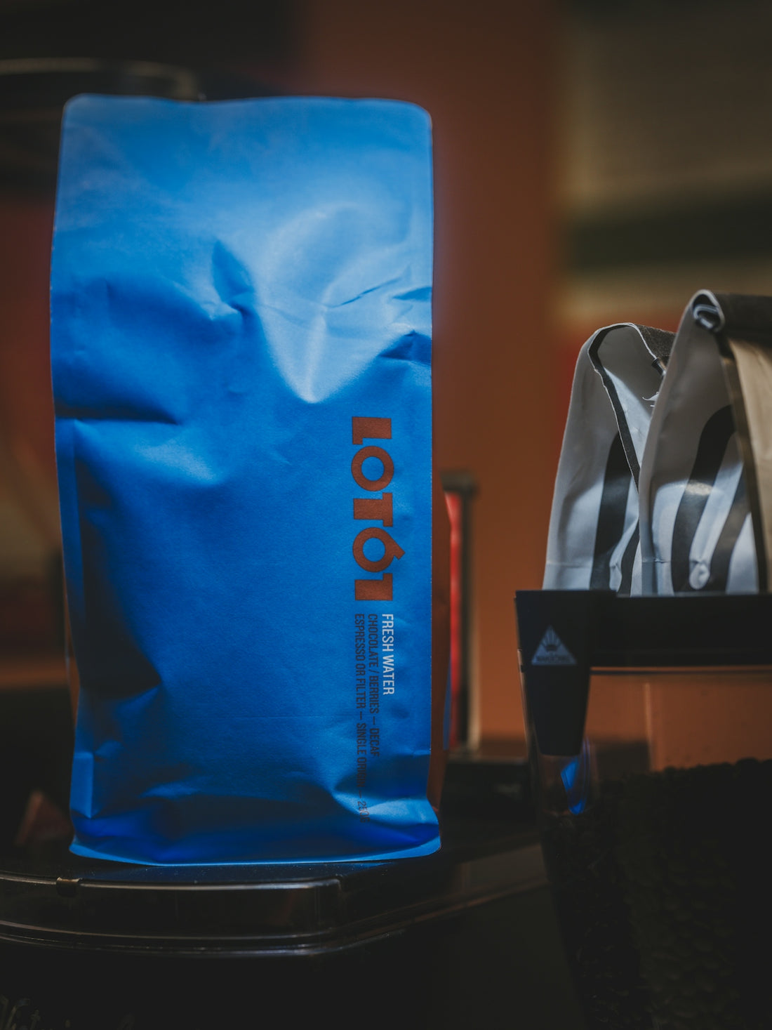 A blue bag with orange lettering sits on a surface