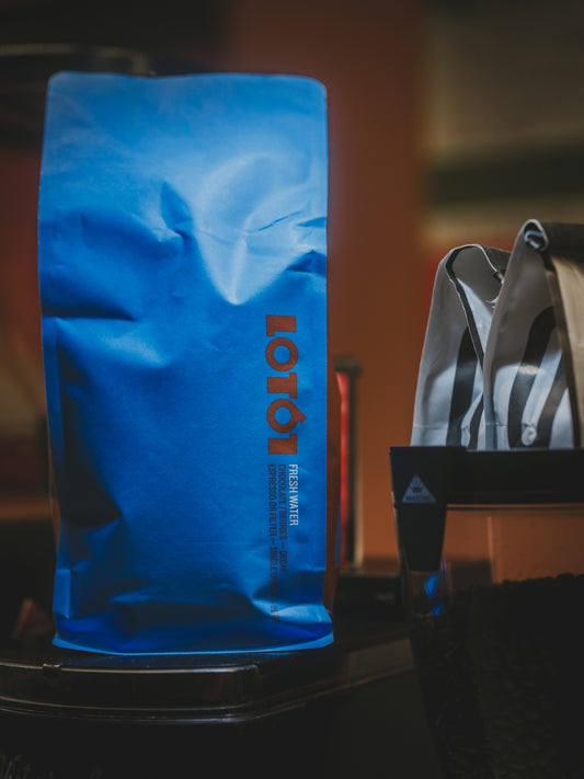 A blue bag with orange lettering sits on a surface