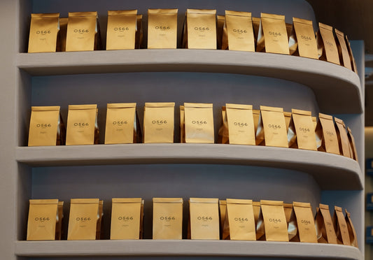 Golden bags displayed neatly on curved shelves.